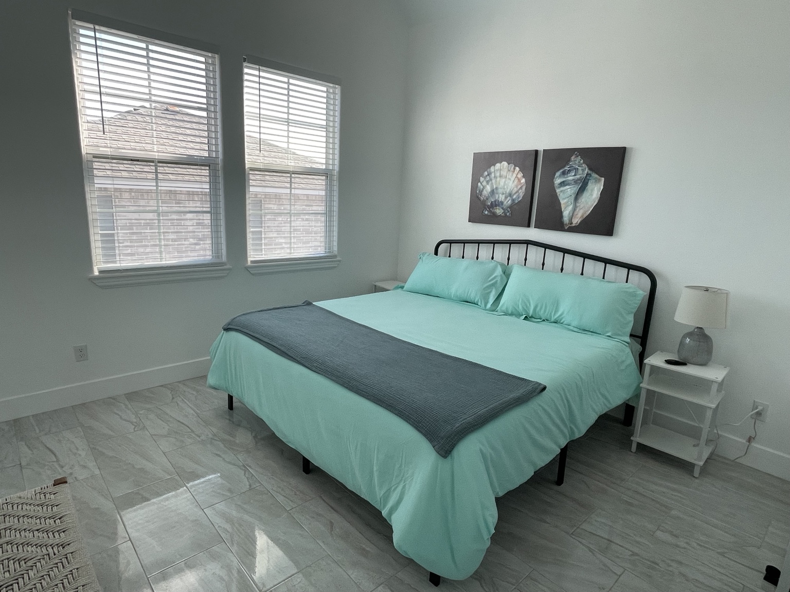 Primary bedroom with a king bed and sea-glass blue bedspread